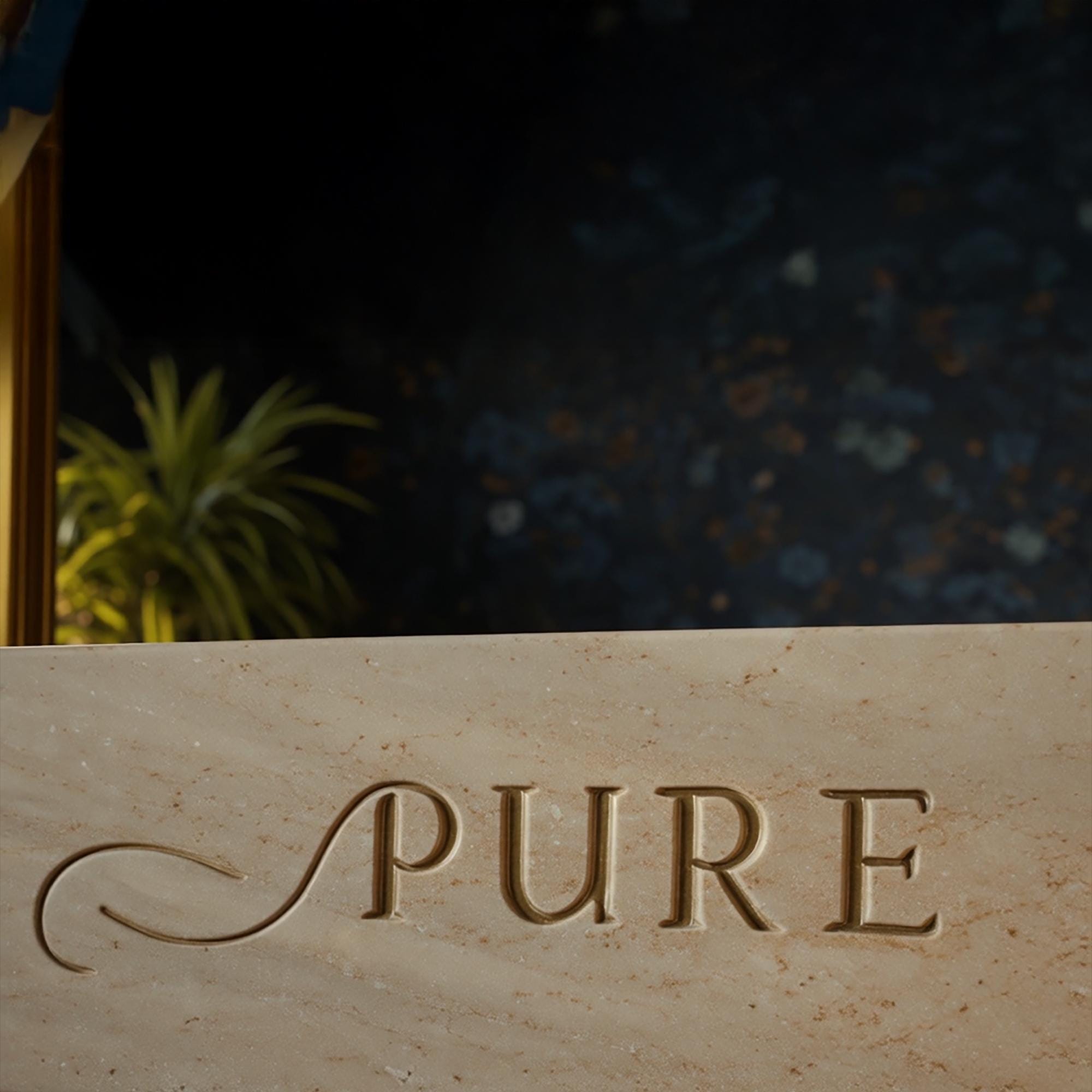 A beige travertine sink with an engraved front panel, featuring a smooth basin surface and natural stone variations.
