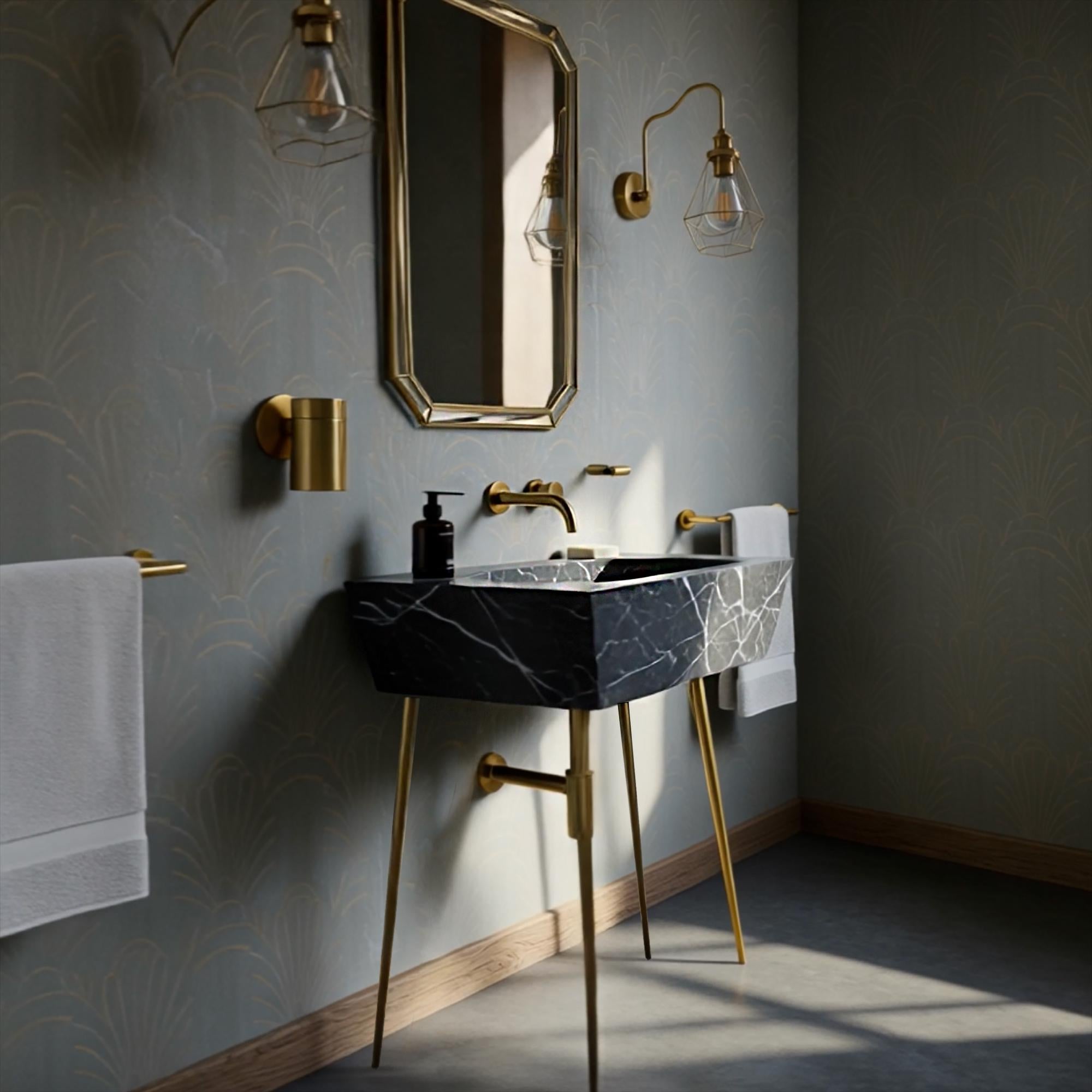 A Nero Marquina marble console sink with brass legs, styled as a striking focal point in a sophisticated bathroom environment.
