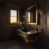 A Nero Onyx marble floating vanity with dramatic black stone and gold veining, paired with brass fixtures in a dimly lit, elegant bathroom interior.
