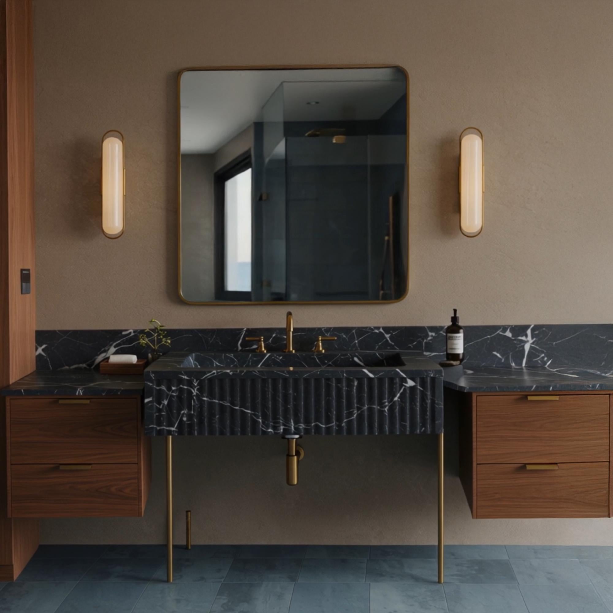 A sculptural Pietre Notte marble fluted console centered between floating wood cabinets, highlighting contrast and clean geometry.
