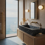 A sculptural black marble fluted sink paired with a floating rattan cabinet, designed for sophisticated modern interiors.