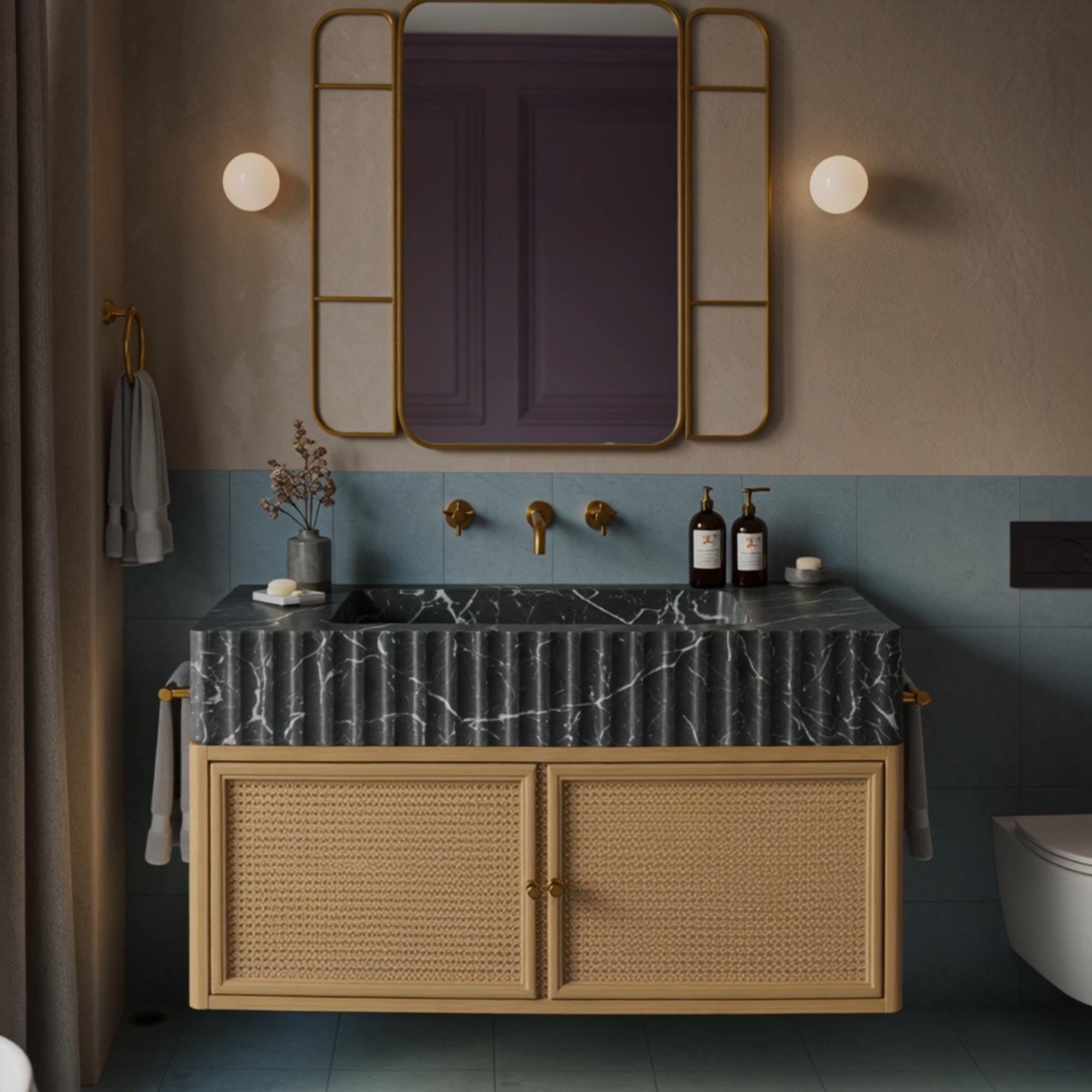 A floating vanity crafted from Pietre Notte marble with fluted detailing and a rattan cabinet for modern organic luxury.