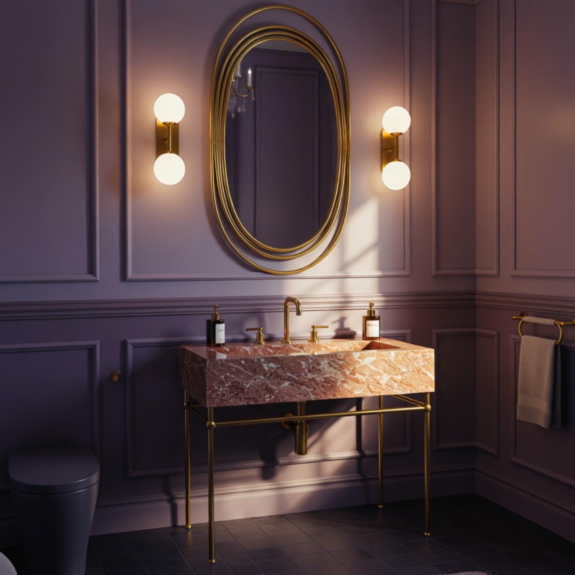 An elegant console sink in polished pink marble with golden fixtures, made for lavish interiors.
