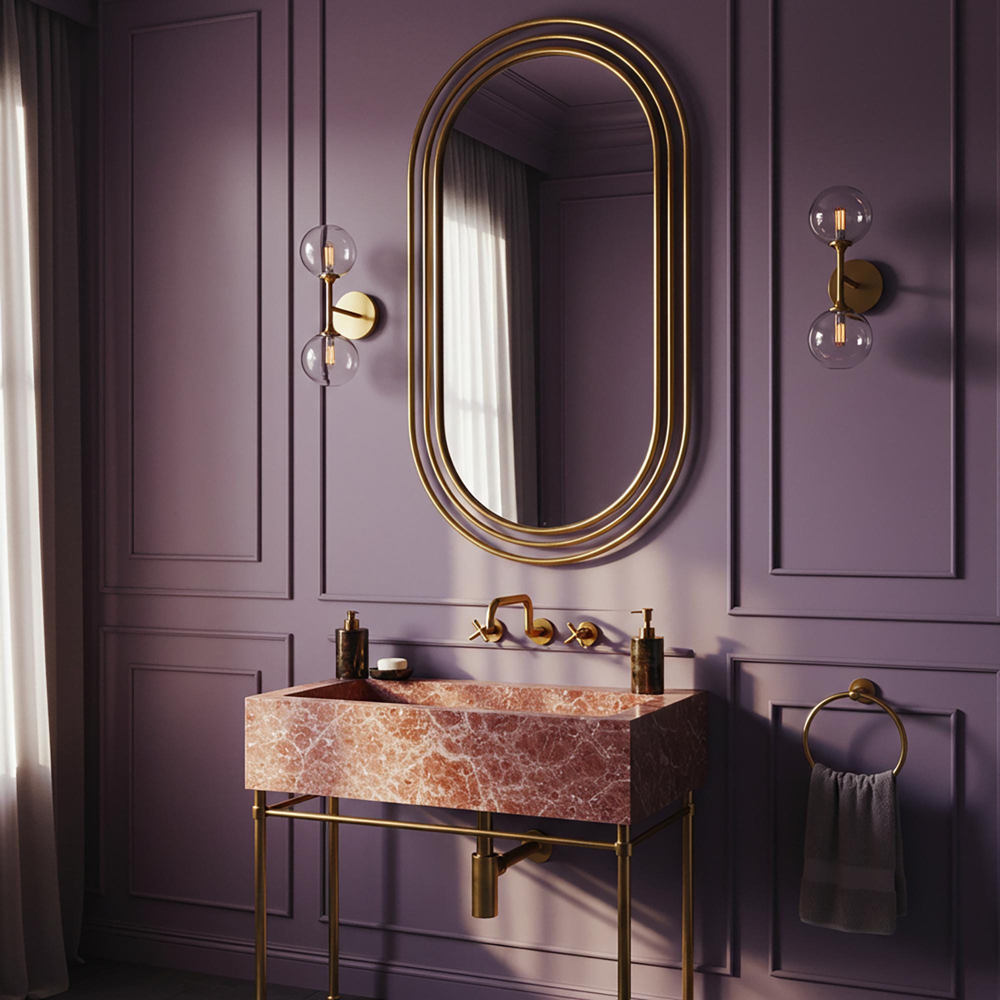 A refined console sink crafted from Rosa Tea marble with a brass base, designed for high-end bathroom aesthetics.