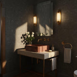 A refined Rosso Levanto marble sink set on a travertine console with a brass stand and integrated towel bar for functional elegance.